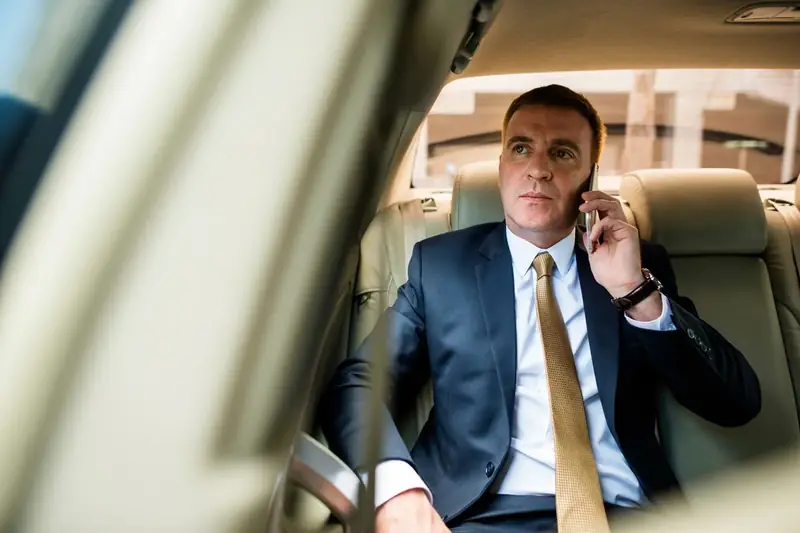 Executive travelling in the back of a black car